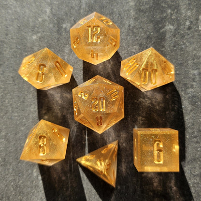 Gold polyhedral dice set on a dark surface